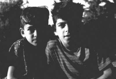 B&W Photo: Two kids holding a cat