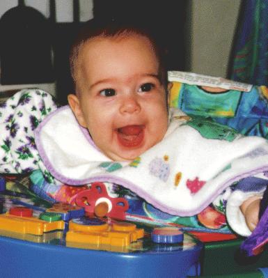 Cute baby girl in exersaucer